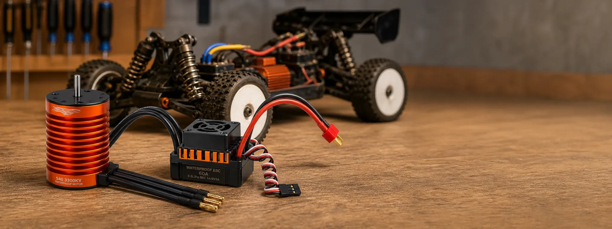 Orange brushless RC motor and waterproof 60A ESC kit displayed on a workshop bench in front of an off-road 1/10 RC car.