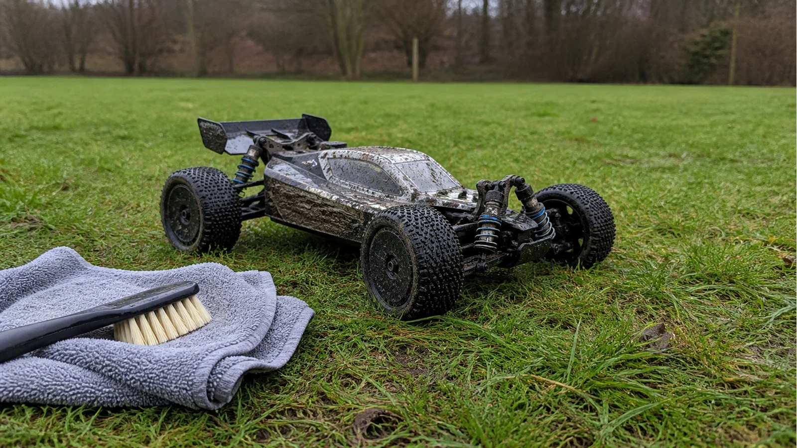 Waterproof brushless RC car on wet UK grass ready for aftercare cleaning